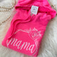 Pink hoodie with 'mama' and a rose design on a fluffy white surface