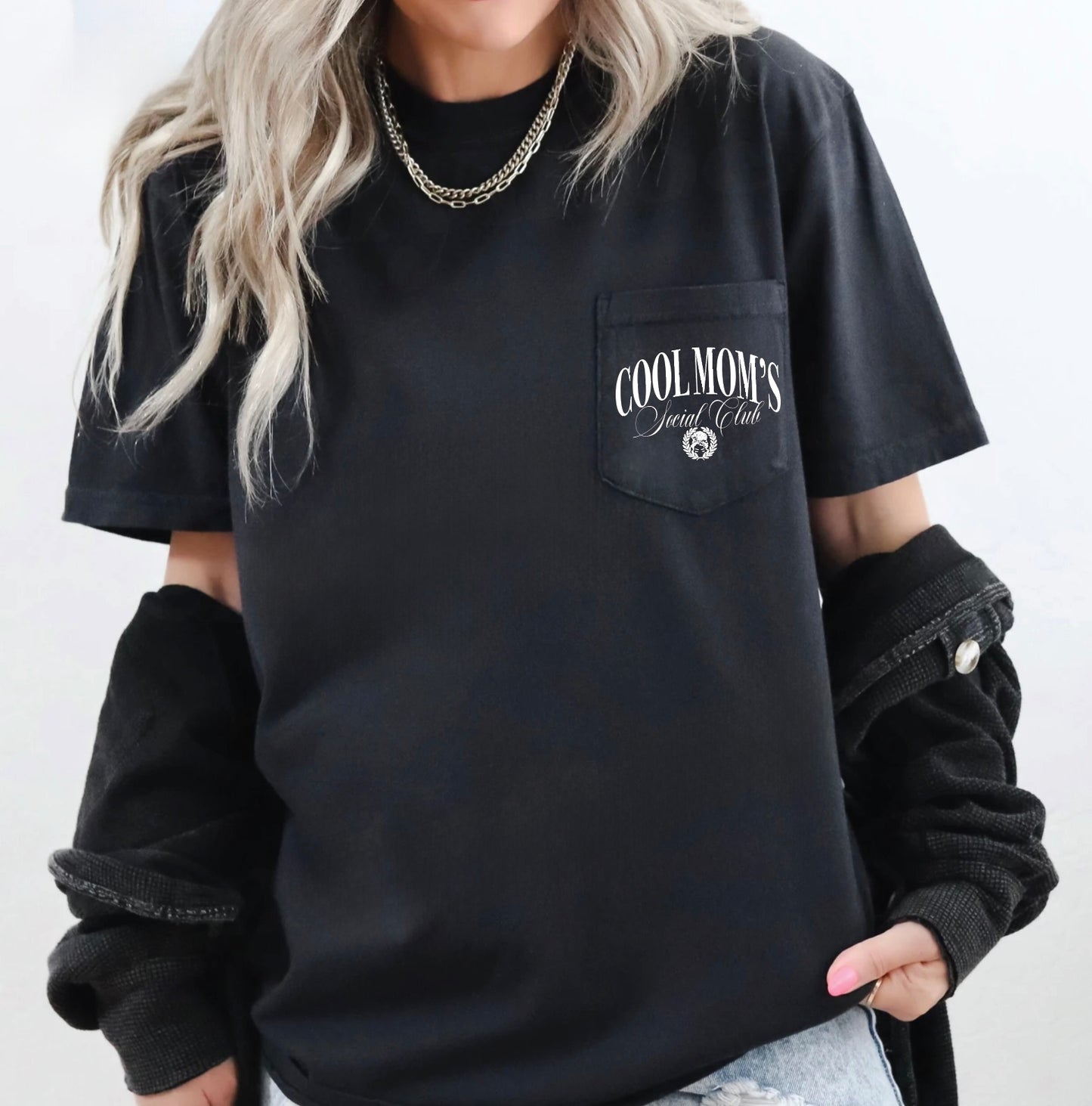 Person wearing a black t-shirt with 'COOLMOM'S' text on a white background