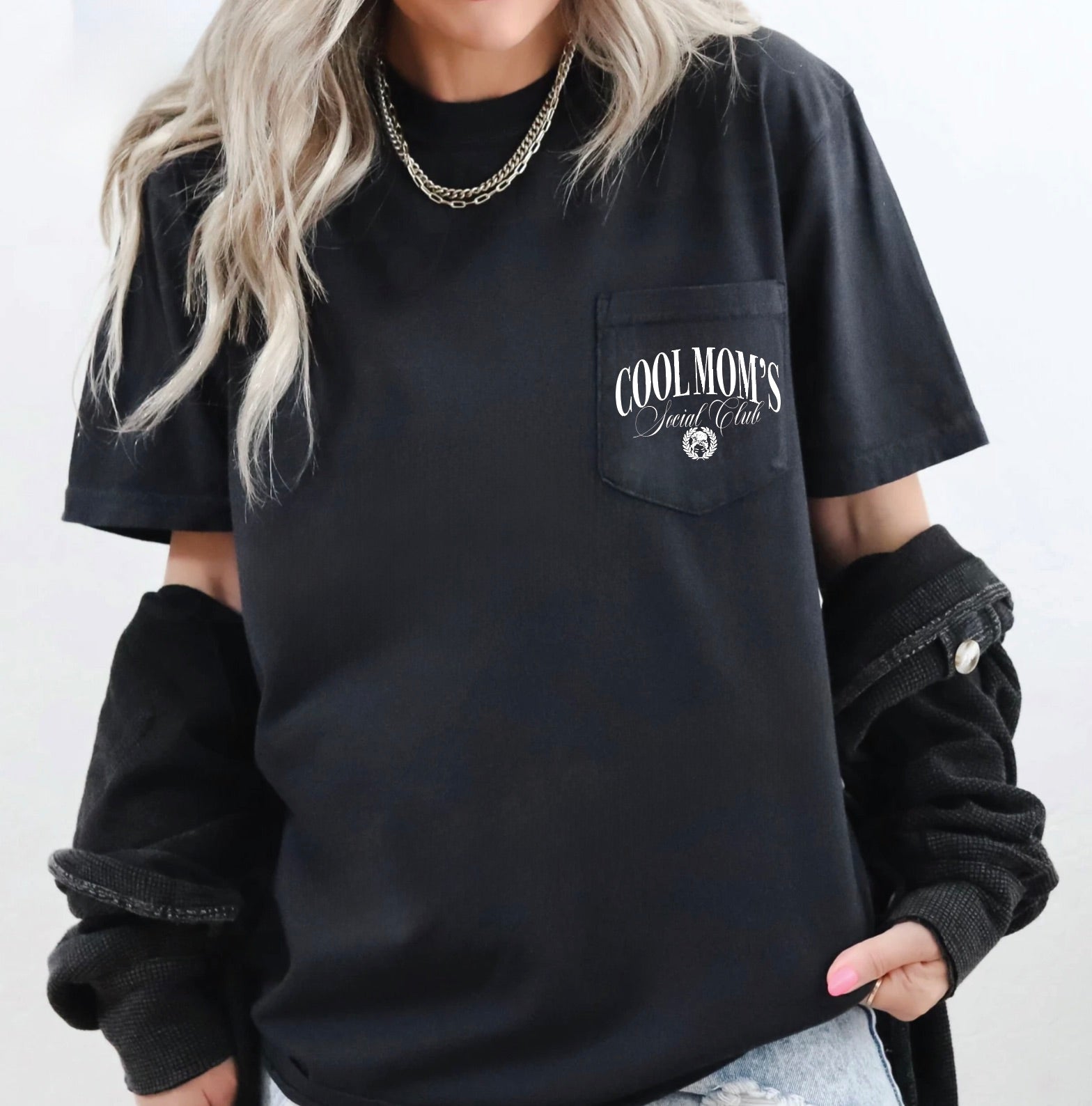 Person wearing a black t-shirt with 'COOLMOM'S' text on a white background
